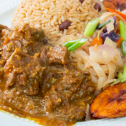 Curried Goat with Coconut Rice Beans Cabbage and Plantains