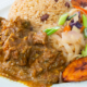 Curried Goat with Coconut Rice Beans Cabbage and Plantains